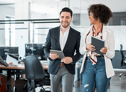 two colleagues walking through their office together