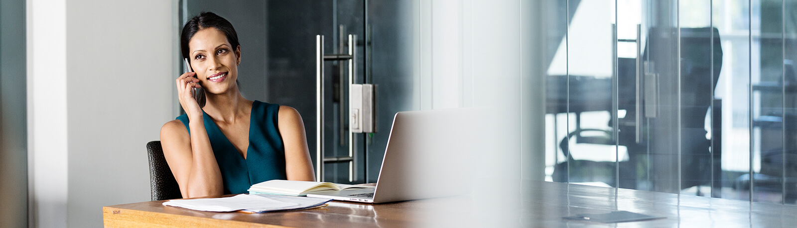 woman talking on the phone at a conference table